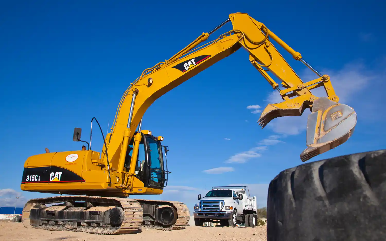 2012 Ford 650 dump truck with an excavator.